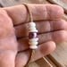 Image of Edison pearl and puka shells bracelet with locking seaglass clasp on hand braided sinew