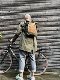 Image 3 of olive green backpack medium size rucksack in waxed canvas, with volume front pocket and double layer