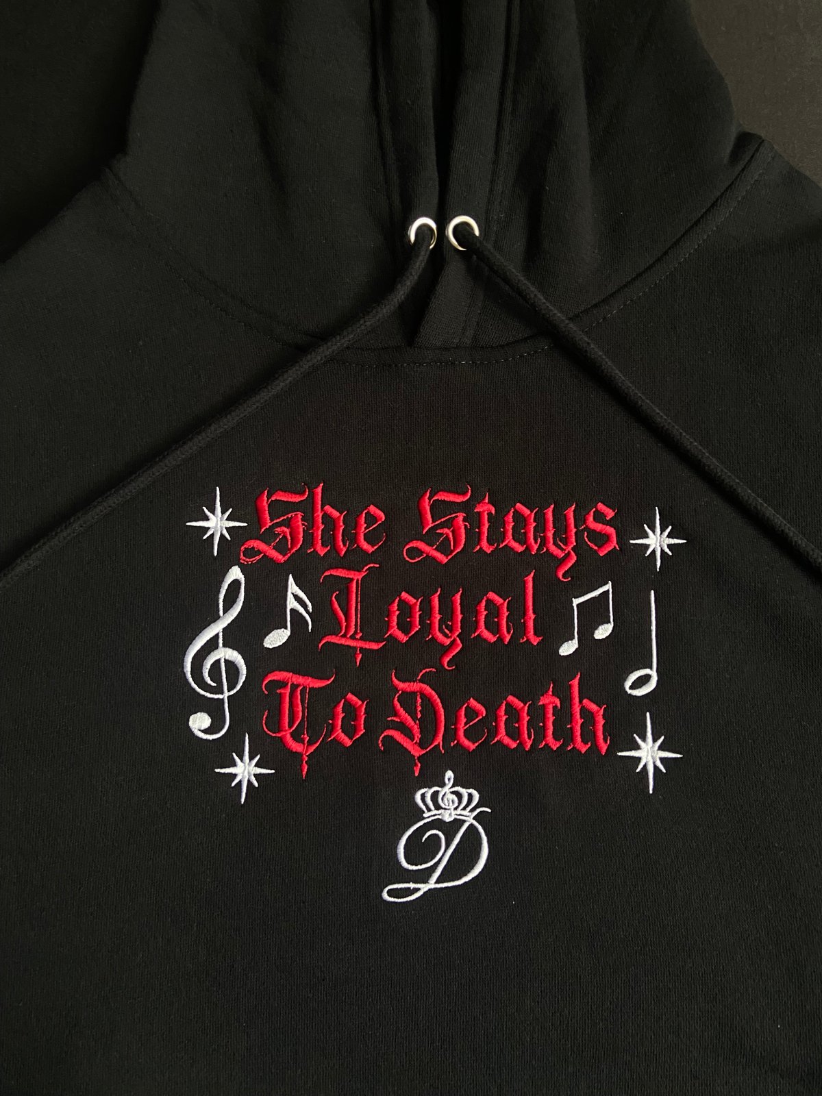 Image of “She Stays Loyal To Death” Hoodie with stars & music notes embroidered (on center of chest)