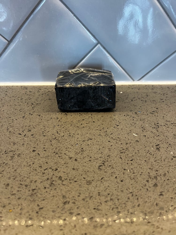 Image of  Black Soap with exfoliating bag