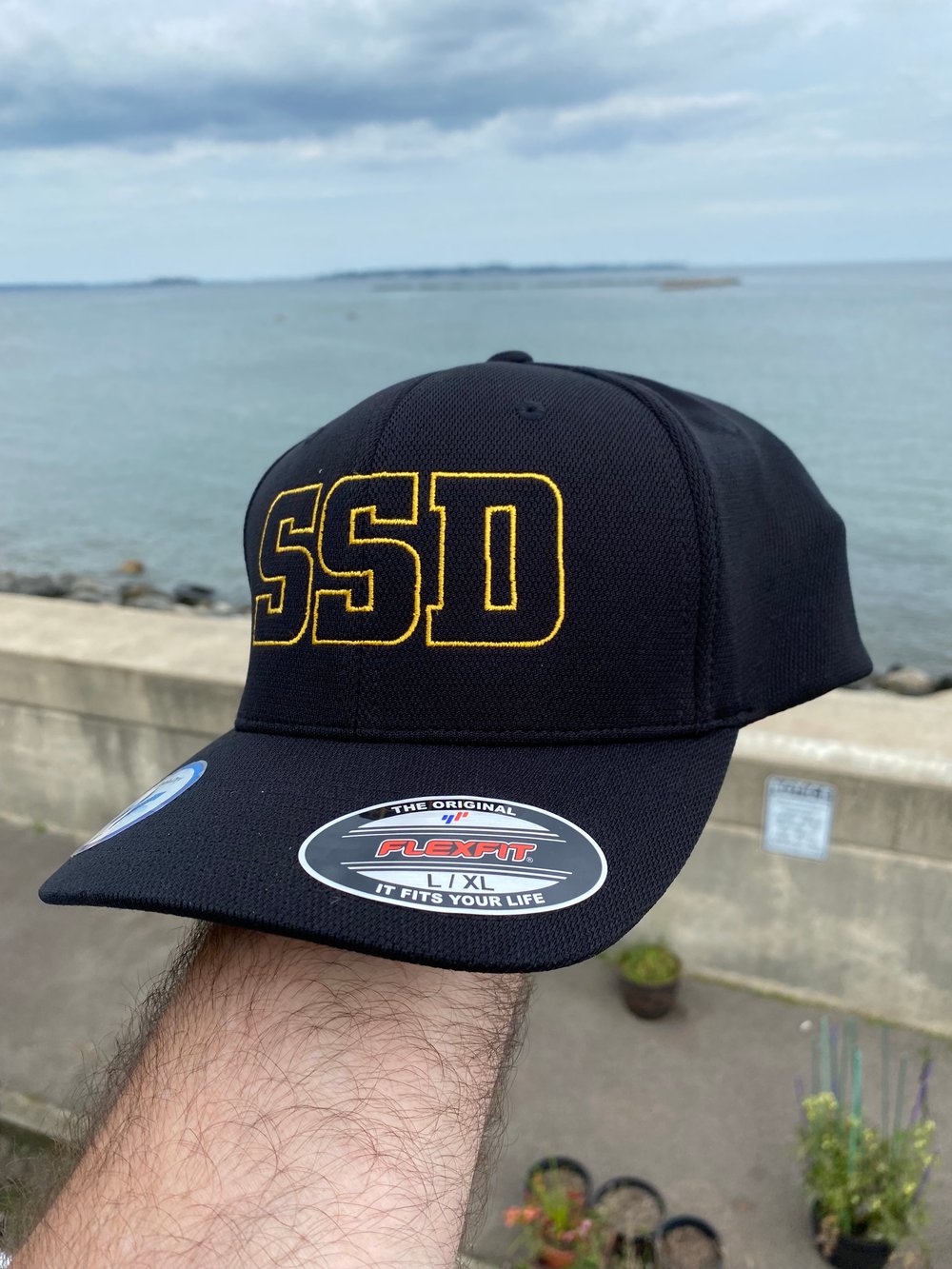 Black fitted Flexfit Hat with Gold SSD Outline Logo