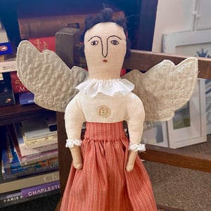 Image of A folk art angel in striped skirt