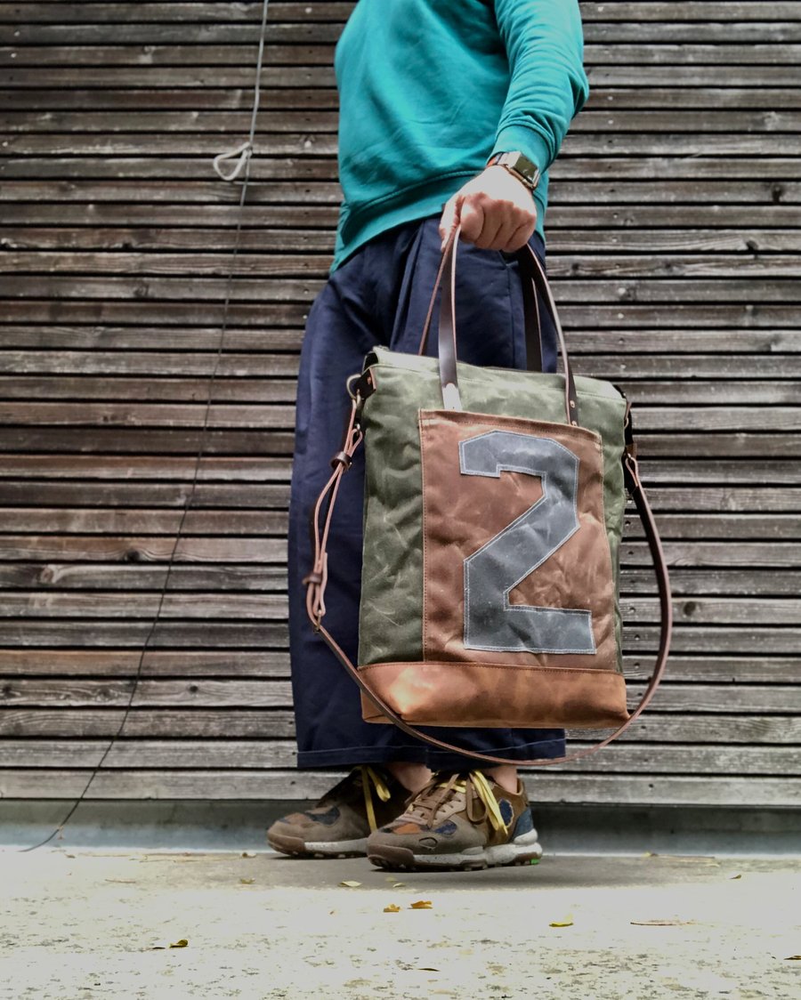 Image of Vertical tote bag made  in waxed canvas with leather straps and cross body strap 