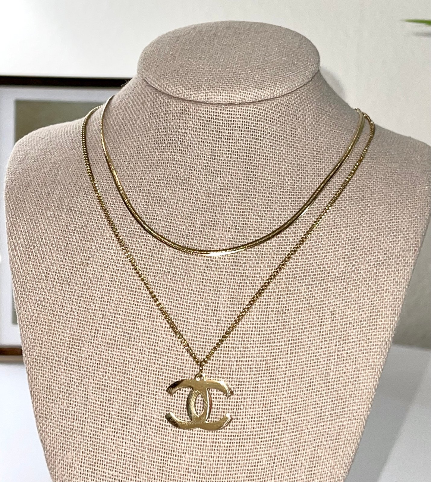 Lot 2  A CHANEL DOUBLE C PENDANT on a chain boxed