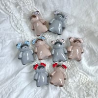 Image 1 of raccoons with bows