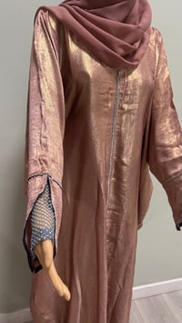 Image 5 of Korean shimmer fabric Flared sleeve abaya rose gold it comes with a matching scarf 