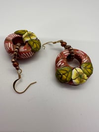 Image 2 of Chunky donuts patterned with cane work and seed beads. Price includes shipping.