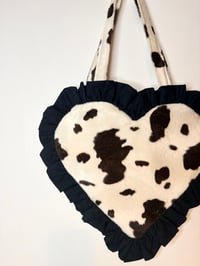 Image 2 of Heart-Shaped Cream & Brown Cow Print Fur Bag with Black Ruffle Trim