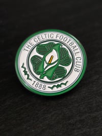 Image 1 of Celtic Crest Easter Lily pin badge.