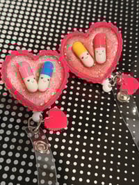 Image 2 of happy pills badge reel 