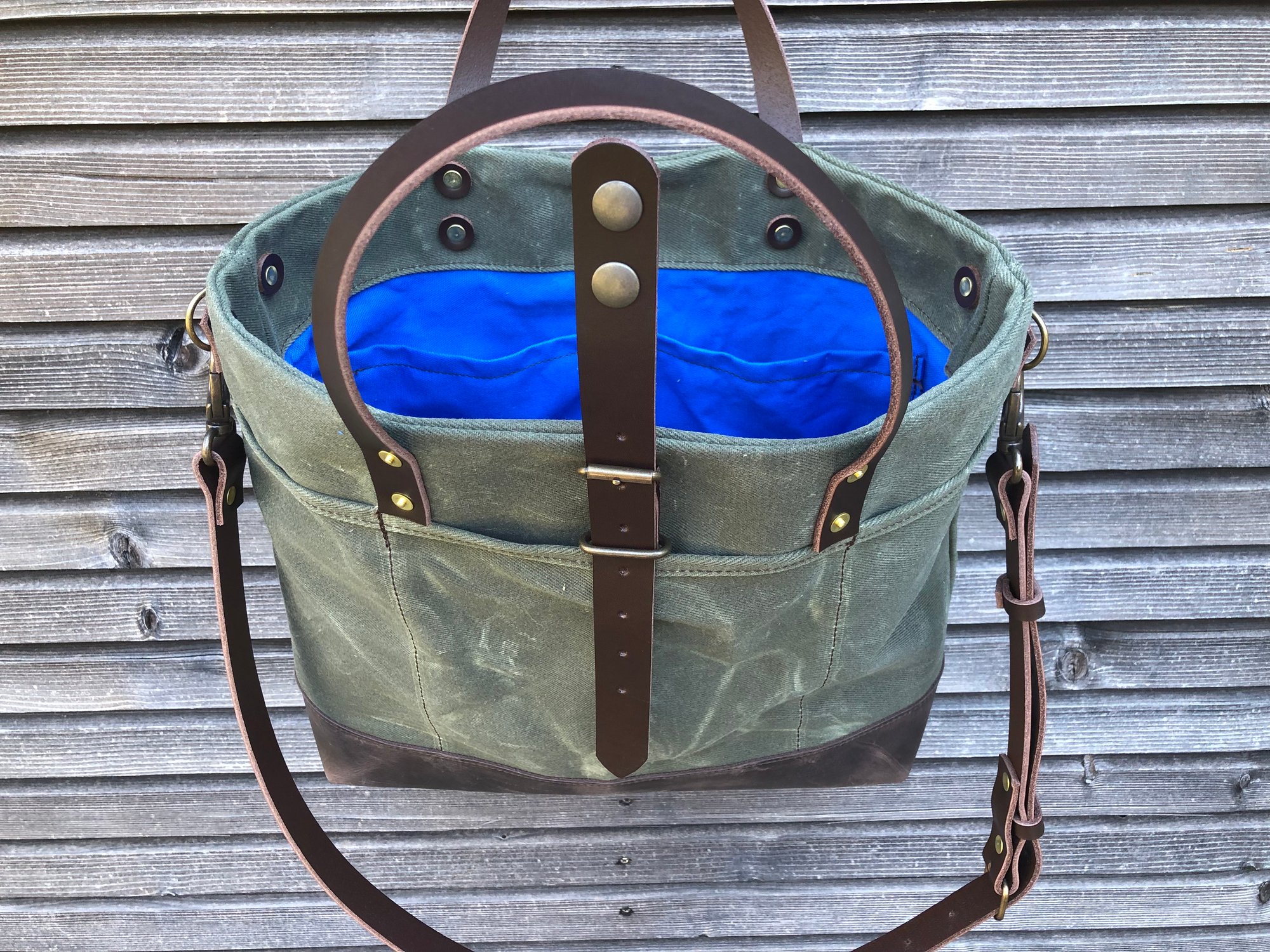 Carryall tote bag in olive green waxed filter twill with leather bottom and  cross body strap