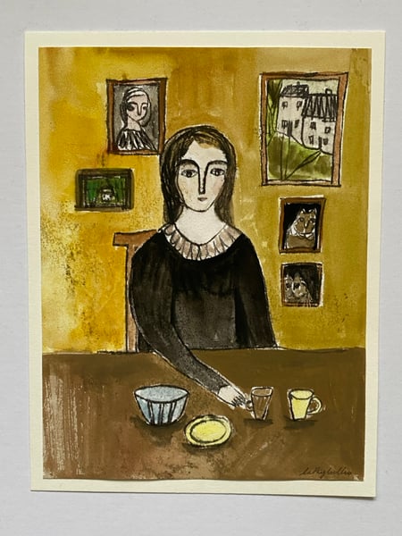 Image of Woman at a table with paintings - monoprint artwork 