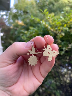 Butterfly, flower and sun earrings in brass