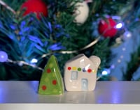 Image 3 of Little House with lights and a Christmas Tree.