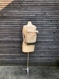 Image 2 of Small waxed canvas backpack  in natural  with rolled top and leather shoulder straps