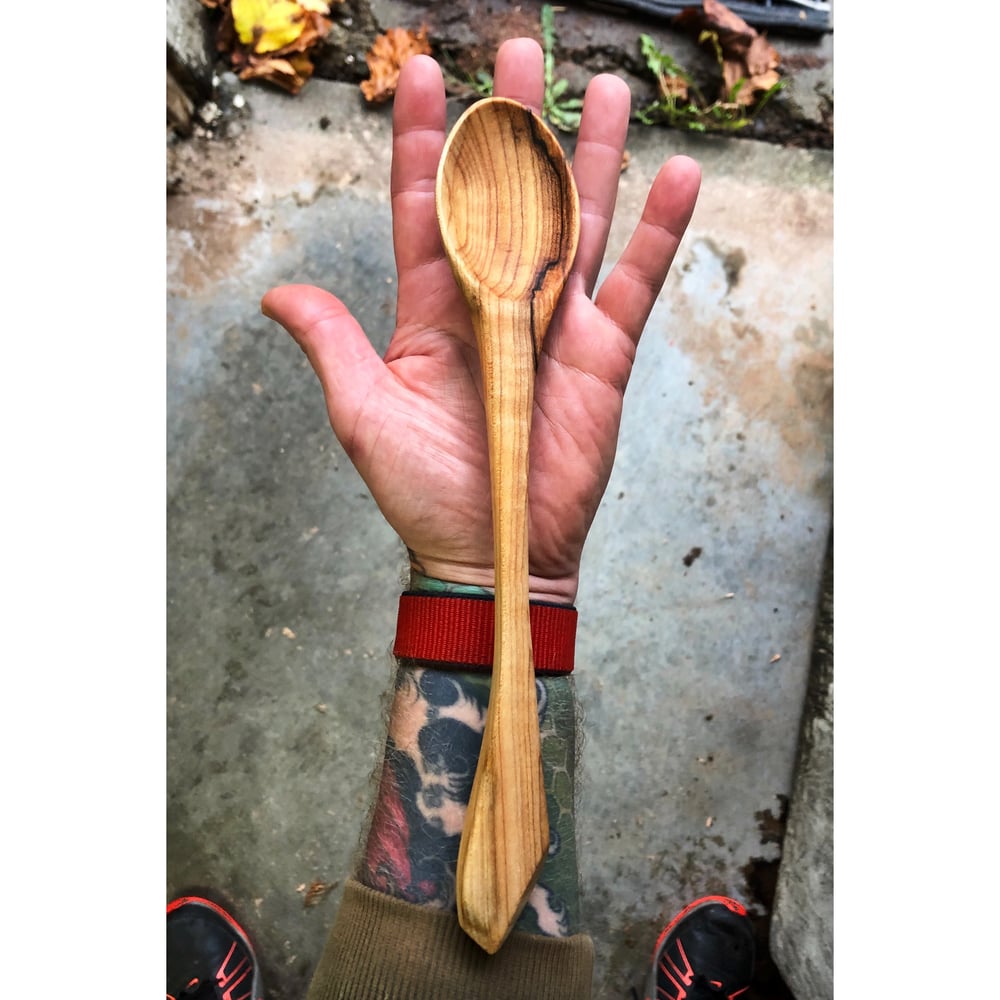 Image of Curly Maple Cook Spoon w/ wee bit of live edge on the handle 