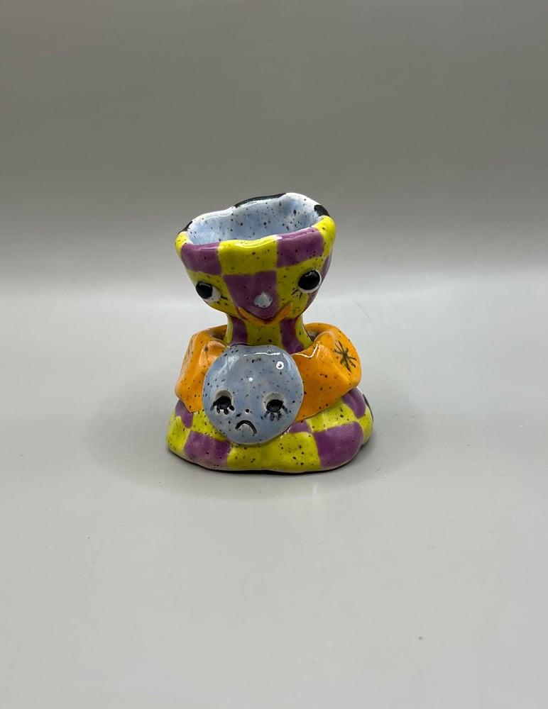 Image of two faced candle holder