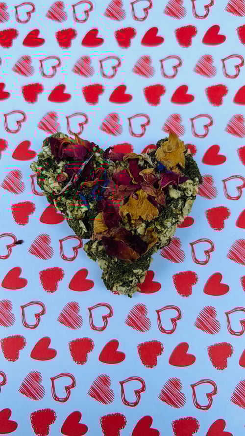 Image of Heart shaped healthy munchy treat bite with rose petals