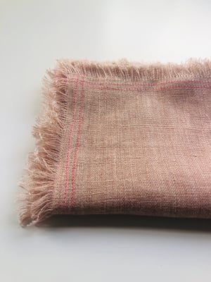 Image of ruby pale orange linen towel with pink stitching