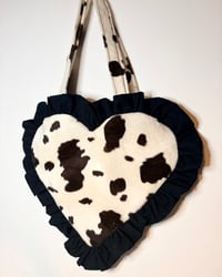 Image 1 of Heart-Shaped Cream & Brown Cow Print Fur Bag with Black Ruffle Trim