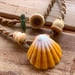 Image of Hawaiian sunrise shell necklace with golden pukas and a locking seaglass clasp