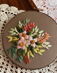 Image 1 of 6” Pink floral embroidery with green leaves on brown fabric 
