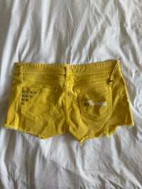 Image 2 of Vintage Y2K low rise yellow shorts with graphic and stud details