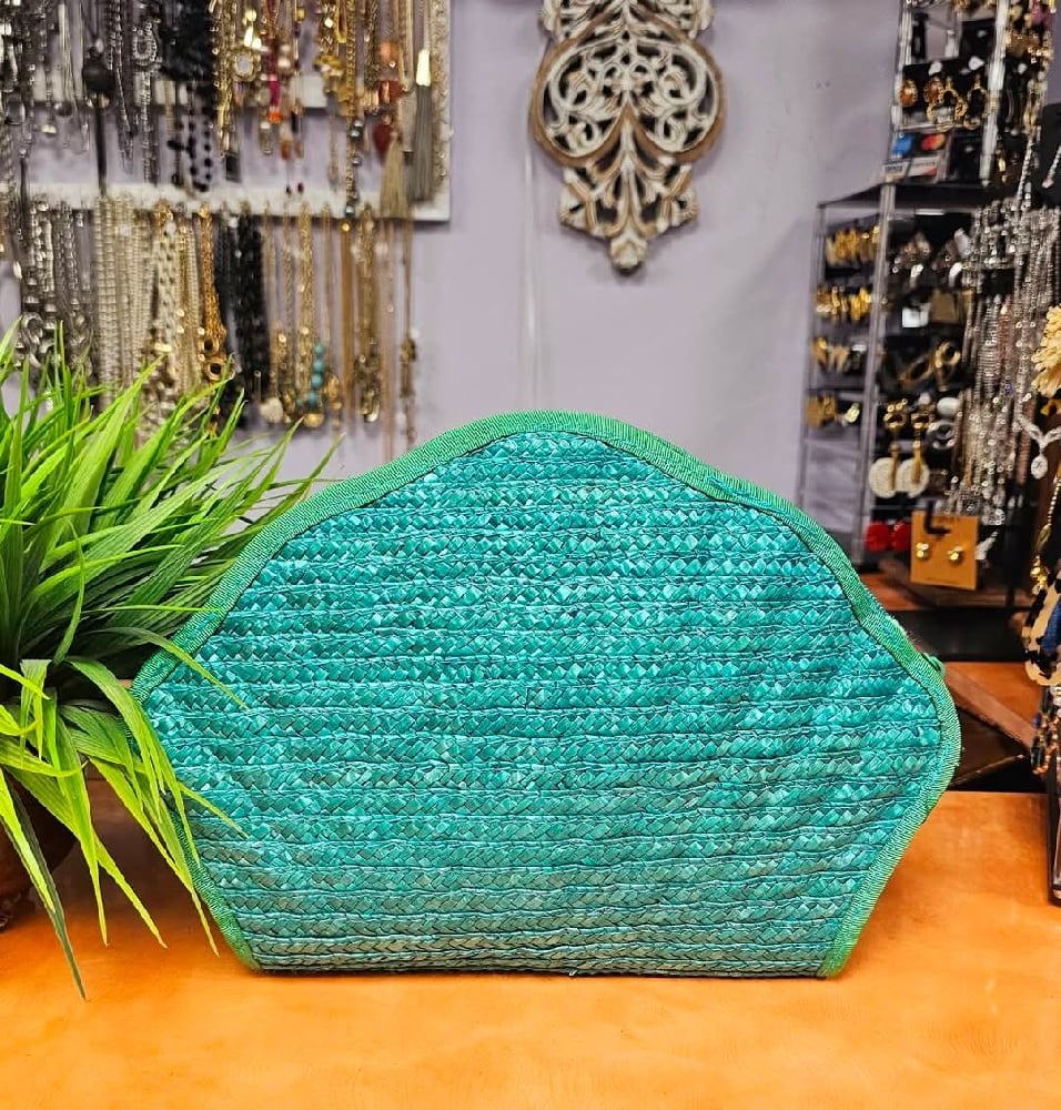 Tan straw and teal bags 