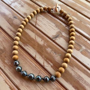 Image of Tahitian pearl necklace with sandalwood beads and a tiger puka shell clasp