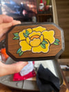 Yellow rose on wood