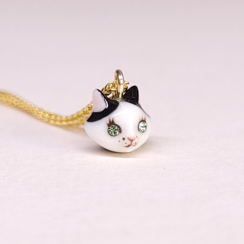 Image of Cow Cat Porcelain & Gold Vermeil Teeny Tiny Cat Pendant
