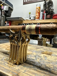 Image 1 of Four Skull Brass Cigar Holder