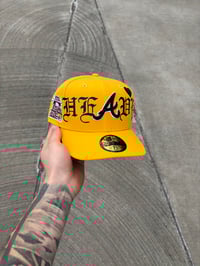 Image 1 of TAXI YELLOW HEAVY HEART ATLANTA BRAVES CUSTOM FITTED CAP