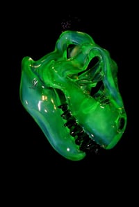 Image 3 of Fully uv reactive green slyme mini T-Rex skull pendant. 💚