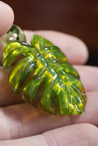 Image 2 of neon monstera leaf pendant. 