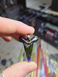 Image 1 of Electrum/amber purple glass shark tooth pendant. 