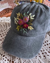 Image 2 of Purple hand embroidered flowers on an adjustable dark green fabric hat