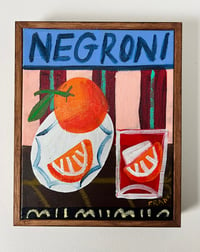 Negroni on pink and claret stripes with orange slice