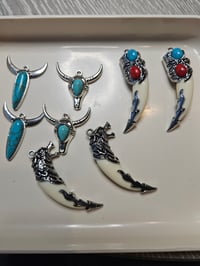 Set of Western-style pendants featuring turquoise and red stone accents. 