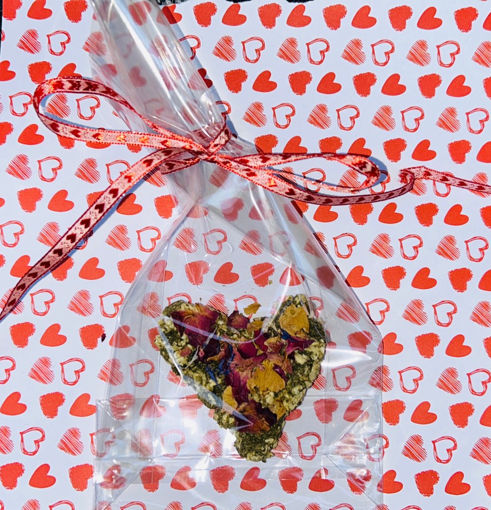 Image of Heart shaped healthy munchy treat bite with rose petals