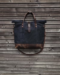 Image 2 of Black waxed canvas roll to close top tote bag with luggage handle attachment 
