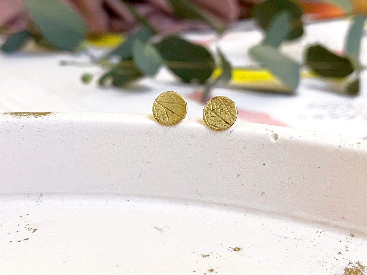 Image of Brass disc stud earrings with hydrangea petal imprint detail. Sterling silver posts.