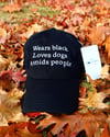WEARS BLACK LOVES DOGS AVOIDS PEOPLE HAT