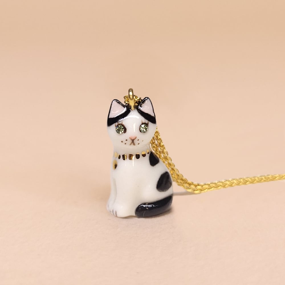 Image of Cow Cat Porcelain & Gold Vermeil Sitting Kitten Pendant