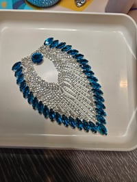 Image 2 of This is a decorative rhinestone applique featuring a teardrop or wing-like shape. 