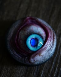 Image 9 of Custom Swappable Phone Grip for smartphones, bright blue reflective pupil, glow in the dark 