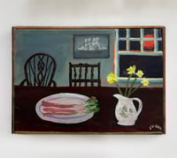 Rhubarb and daffodils on table by red moon
