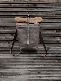 Image 1 of Leather backpack with waxed canvas roll to close top and double outside pocket