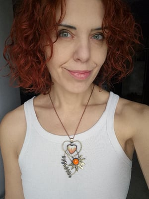 Heart pendant with orange flower