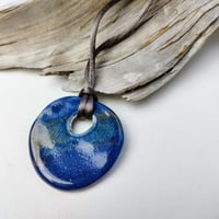 Image 1 of Flattened pebble cut-out pendant deep blue/bronze